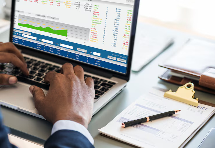 Professional reviewing governance, risk, and compliance data on a laptop