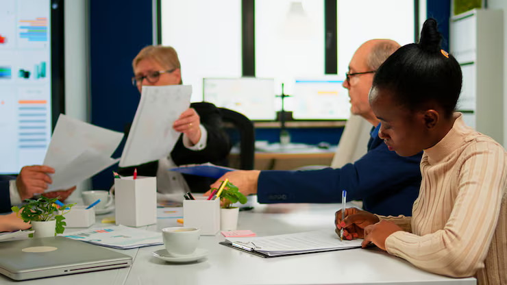 Compliance professionals collaborating on Canadian financial GRC documentation