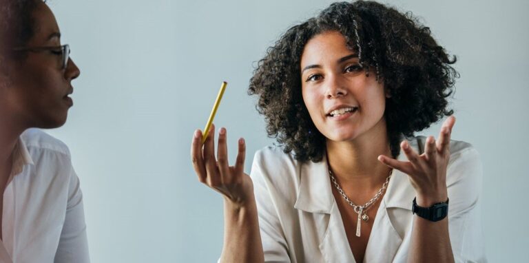 A woman holding a pencil in her hand.