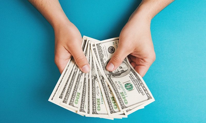 A person holding money in their hands